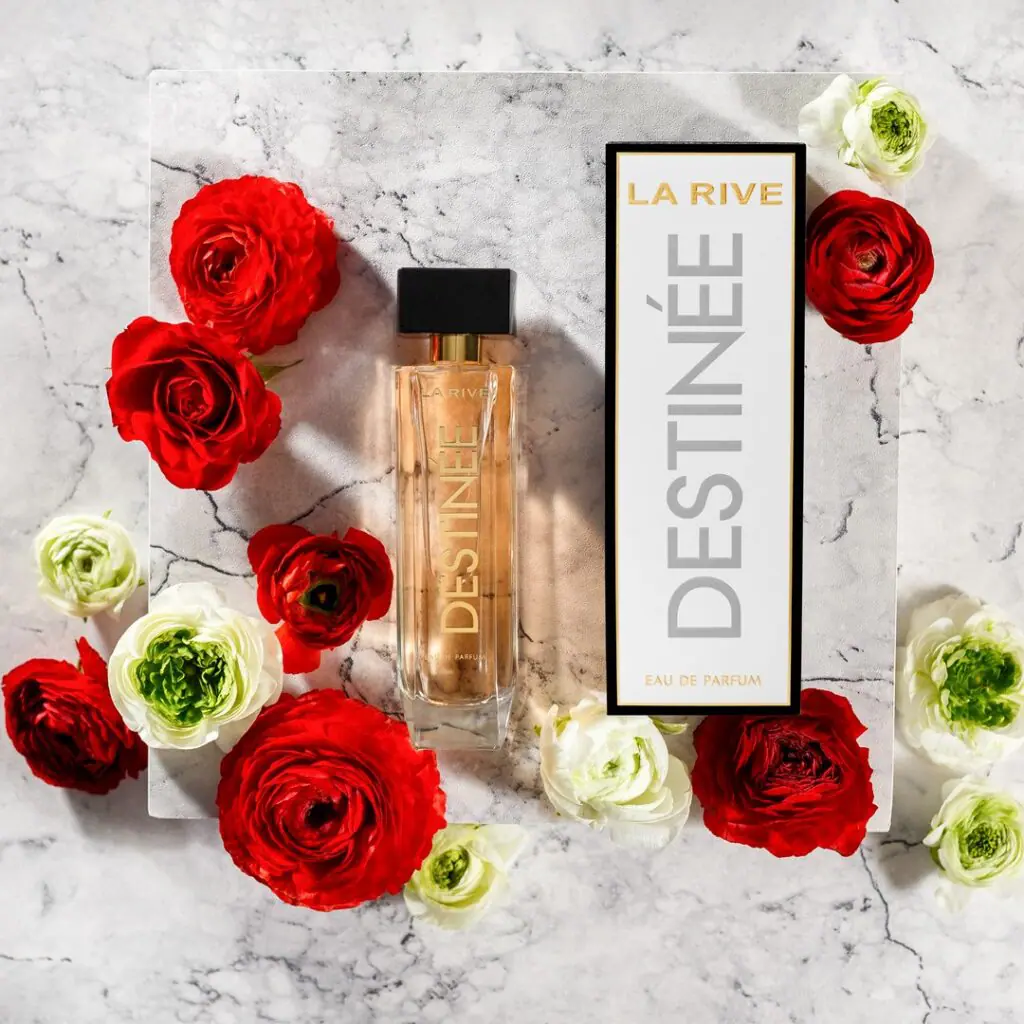 Perfumy La Rive Destinée z czerwonymi różami na marmurze — aranżacja produktowa